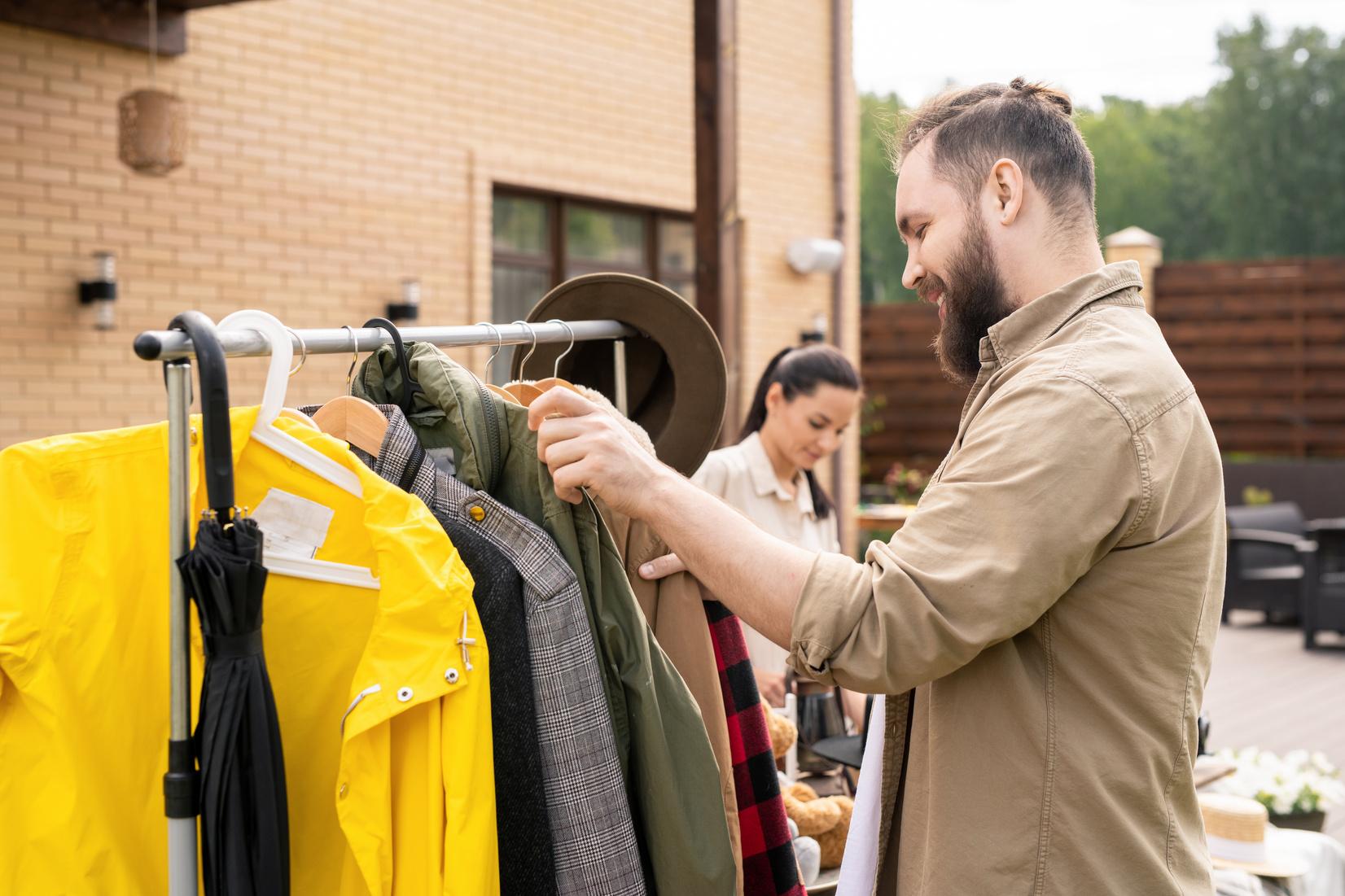 Man Choosing Clothes at Yard Sale